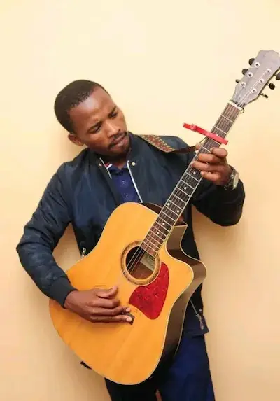 Thabo "Go Slow" Machi playing guitar
